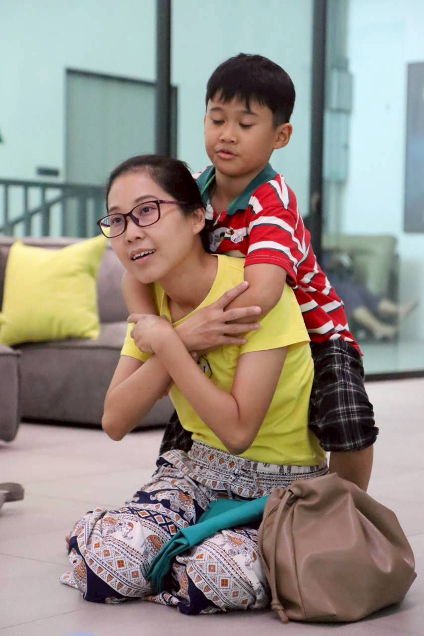 A caregiver holding a child with warmth and presence