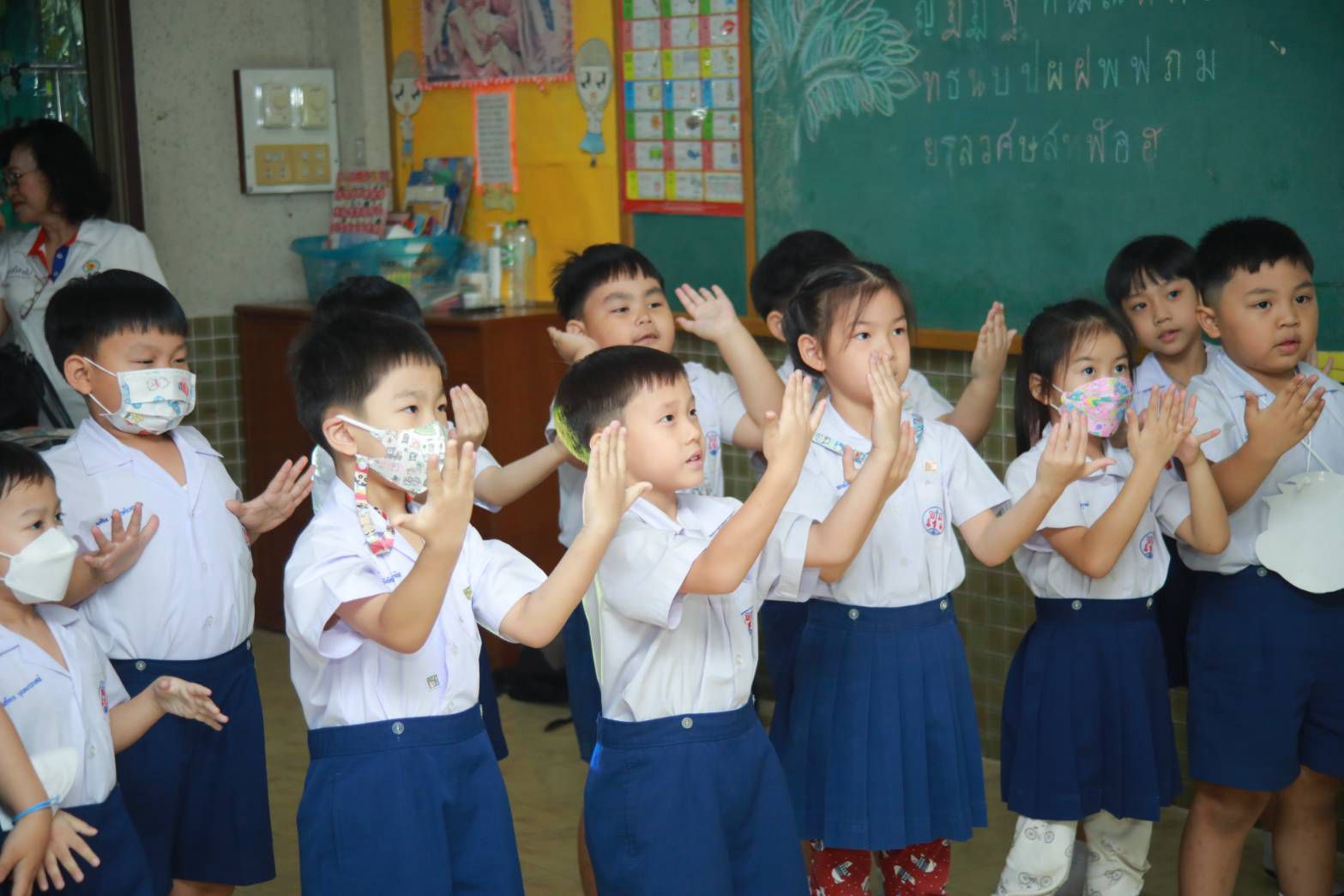 Children practising a calming hand gesture together